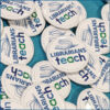 Button pins with Librarians Teach logo scattered on a table.